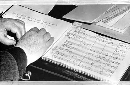 Darius Milhaud rests his hands on score for Octuor a Corde